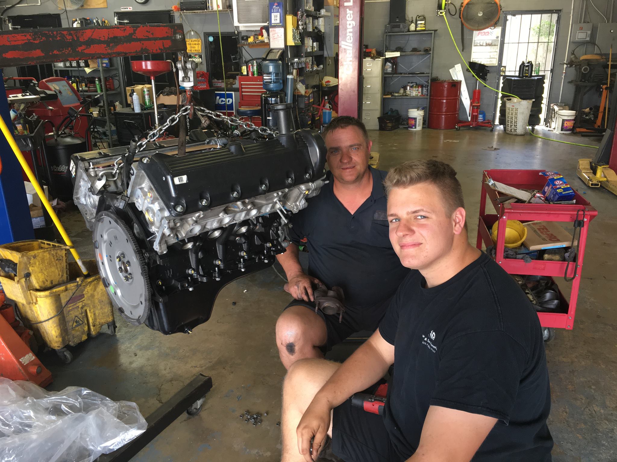 Brandee and Brandon working on an engine together