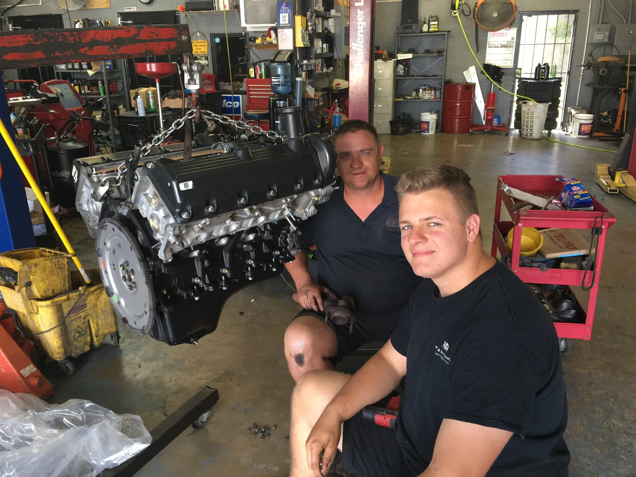 Brandee and Brandon working on an engine together